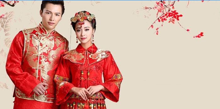 Uma garota e um cara em trajes folclóricos chineses