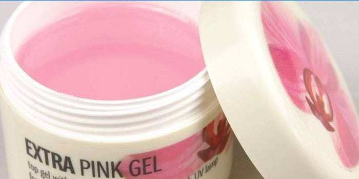 Base de gel rosa para extensão de unhas em uma jarra