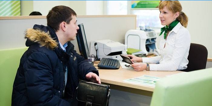 Um homem conversa com um consultor do Sberbank