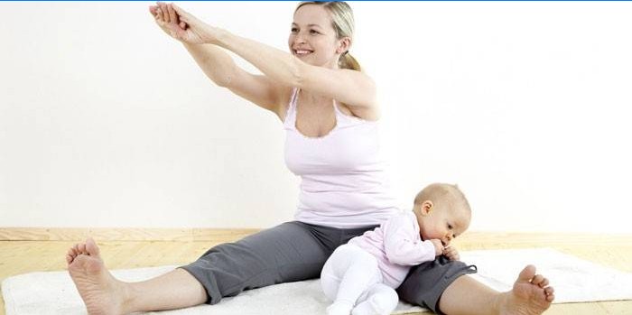 Jovem mãe faz exercícios com seu bebê
